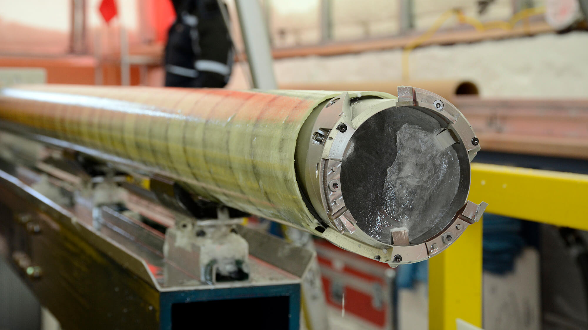 A close-up view of an ice core still in the Foro 1650 drill barrel. Credit: Peter Rejcek