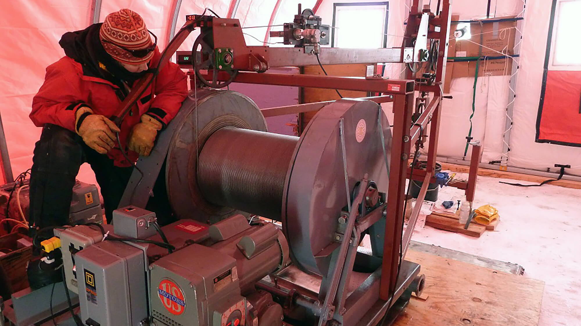 IDP driller/winch operator Elizabeth Morton assists with borehole logging operations at WAIS Divide, Antarctica, during the 2011-2012 summer field season. Credit: Kristina Slawny