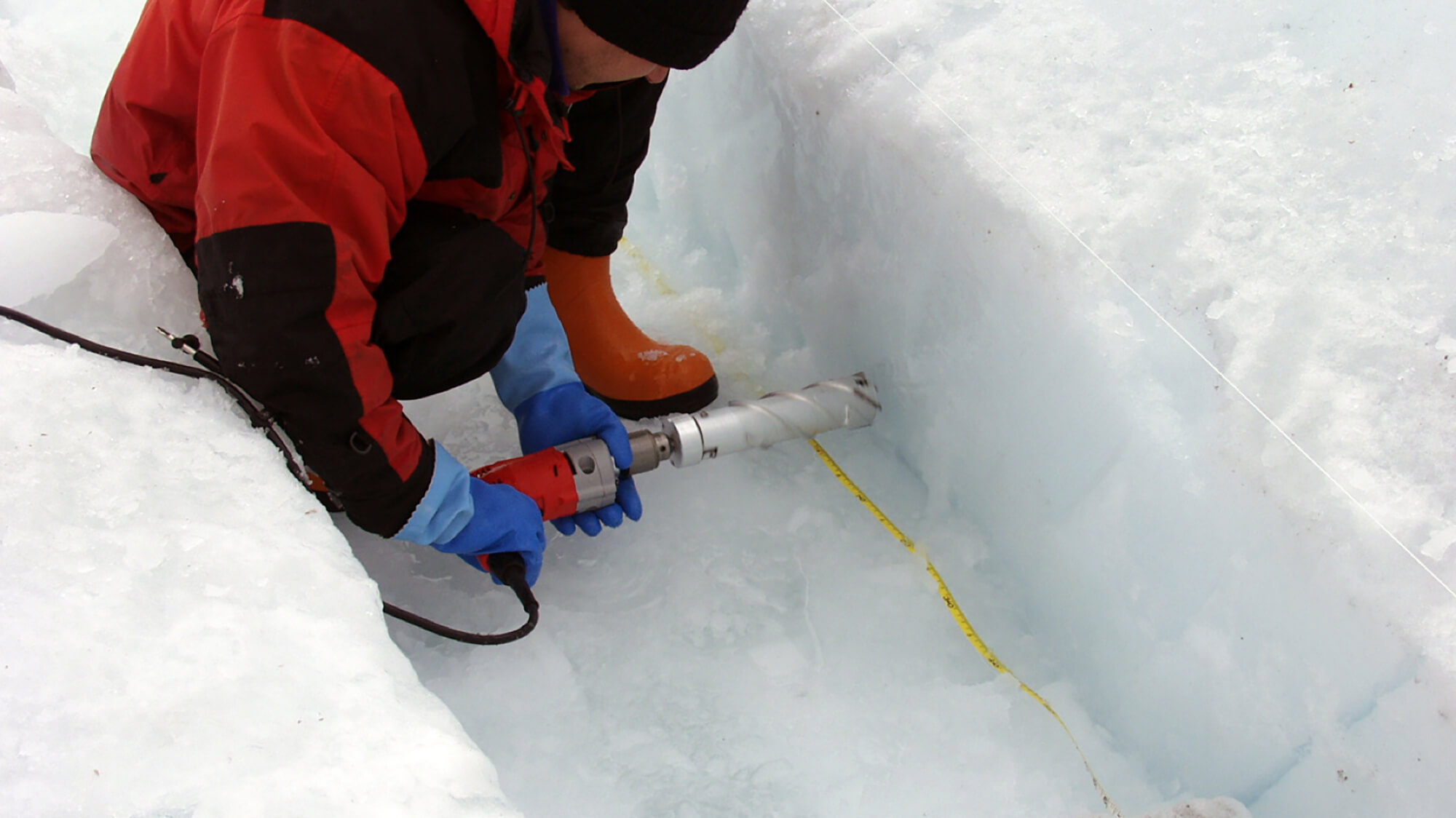 A scientist uses the Chipmunk Drill at Pakitsoq, West Greenland, in 2004 to recover samples of ice. Credit: Ed Brook