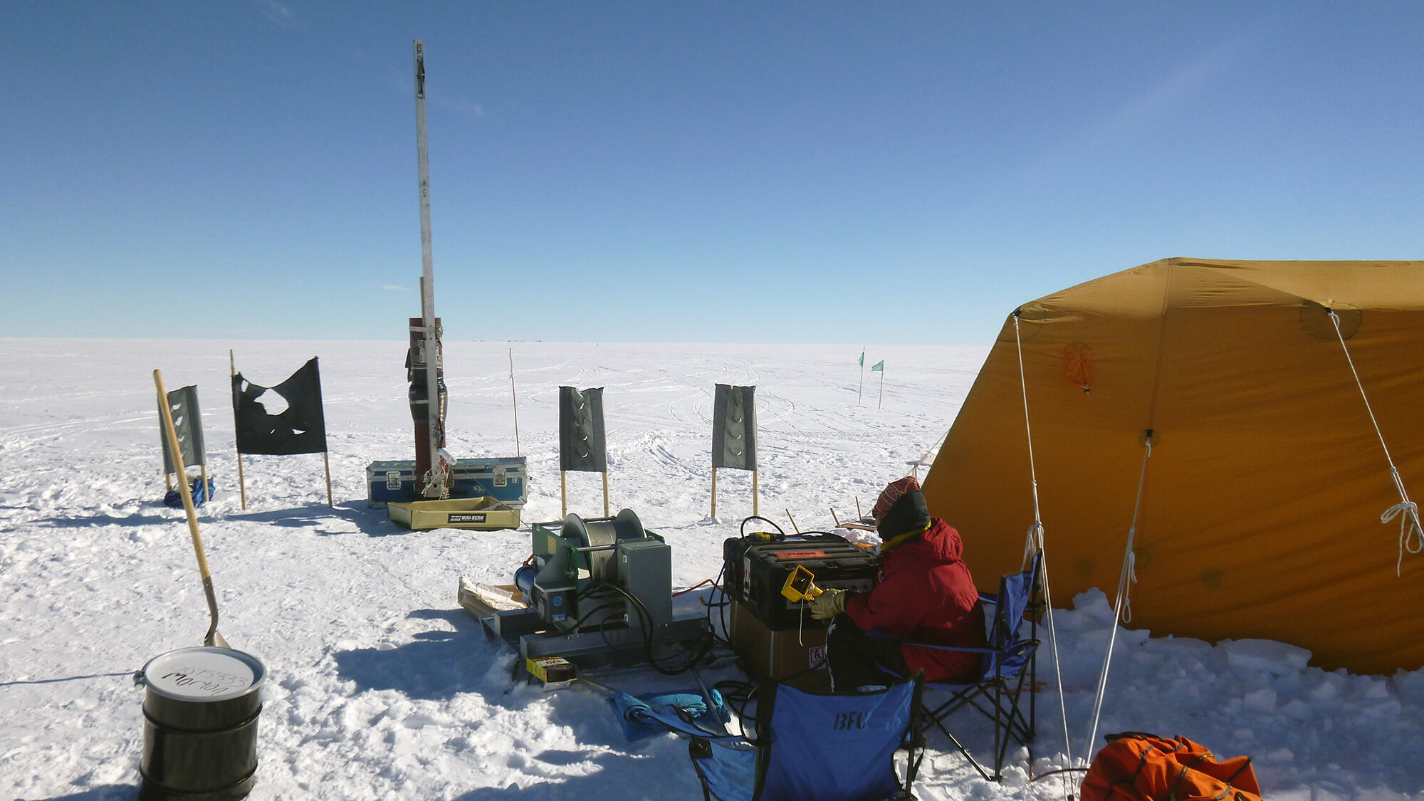 The intermediate depth logging winch in operation at Siple Dome, Antarctica, during the 2013-2014 summer field season. The logging tower is strapped to the Siple Dome borehole casing. Credit: Josh Jetson